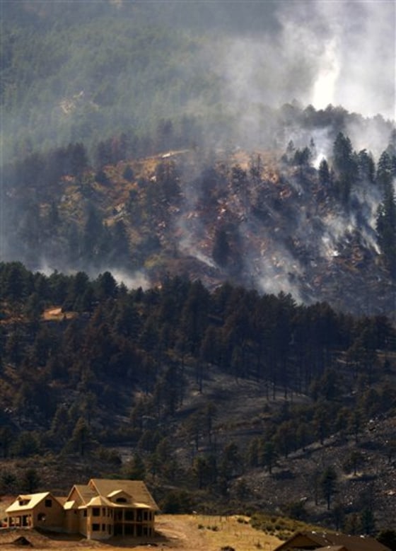 A wildfire burns in Loveland, Colo. on Sept. 13. Firefighters worked Monday to control a wildfire that destroyed at least two homes in the northern Colorado foothills as authorities said the blaze and another one that burned at least 166 homes were sparked by household fires.